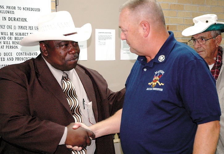 Jeremy D. Smith/The Demopolis Times -- Sheriff-elect Richard E. "Ben" Bates shakes hands with opponent Bobby Duke Tuesday night as the latter concedes the election.