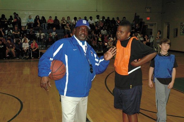 Jesse Bell talks with a student during Demopolis Middle School's fundraising tournament Friday.