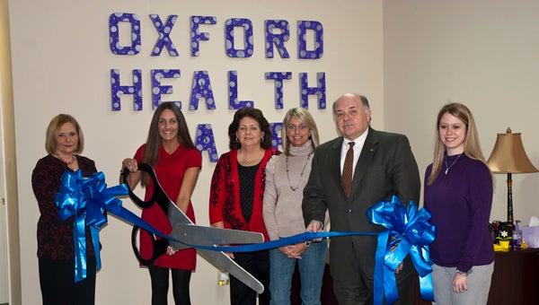 Oxford Healthcare held a ribbon-cutting ceremony Thursday morning in honor of their merger with Helping Hands of Alabama. Shown from left to right are Gwen Hill, staffing and scheduling coordinator for Oxford; Kristy Braswell, branch manager; Debbie Braswell, secretary; Jenn Tate, Demopolis Area Chamber of Commerce executive director; Demopolis Mayor Mike Grayson; and Brooke Carlisle Johnson, billing and payroll coordinator.