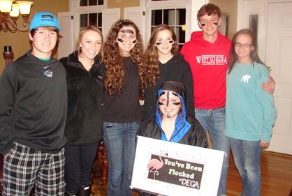 The Demopolis High School DECA club are ‘flocking’ local residents as a part of a fundraiser to raise money for their conference to Anaheim, Calif. Shown are Walker Davis, Sutton Aiken, Taylor Cooper (kneeling), Rachel England, Kathlene Saliba, Logan Boone and Bailey Petrey. 