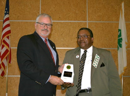 Lamar Nichols, assistant director for 4-H Youth and Development presents the 4-H Wall of Fame award to William Norwood for his work with 4-H in Marengo County.