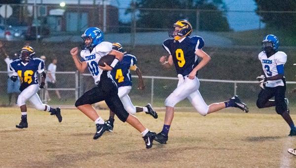 Demopolis Middle School quarterback Russ Logan ran for a 35-yard touchdown Monday night against Sweet Water.