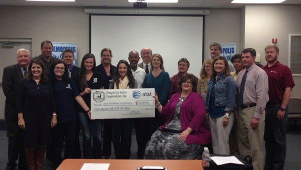 Members of the Demopolis Board of Education, the Demopolis City Schools Foundation board of directors and others associated with Demopolis High School's Dual Enrollment Program are shown receiving money from AT&T for the program.