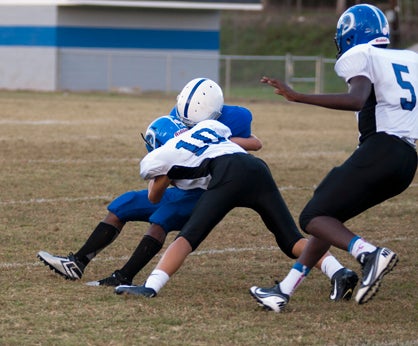 Russ Logan makes a tackle in the backfield for a loss.
