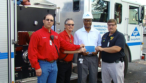 Shown from left are volunteer firemen Milton Vick and Mike Carlisle, GP Mill Manager Kelvin Hill and Linden Police Chief Scott McClure.