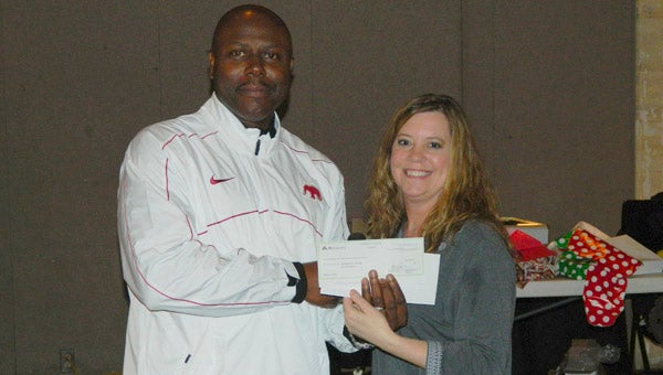 Shown is Melanie Soronen, president of the DCPAAA, presenting a check to DPD Chief Tommie Reese.