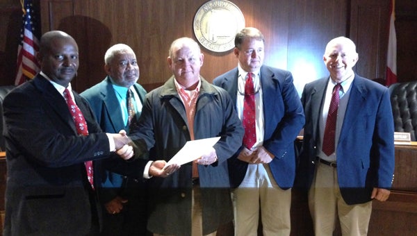 The Marengo County Commission adopted a resolution honoring the Marengo Academy state championship football team. Shown from left are Commissioner Calvin Martin, Commissioner Freddie Armstead, Marengo Academy head coach Robby James, Commissioner John Crawford Jr., and Commissioner Dan England.