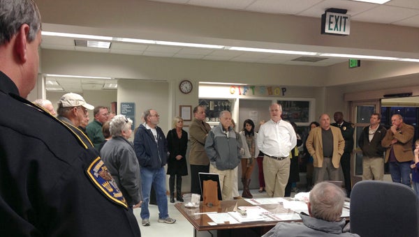 Hospital board member Jay Shows (white shirt, fifth from right) addresses the crowd that came out to the hospital Wednesday evening.
