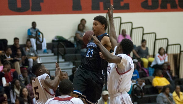Demetrius Kemp goes airborne to pass the ball off to a teammate in Friday night’s season-ending loss to Sumter Central.