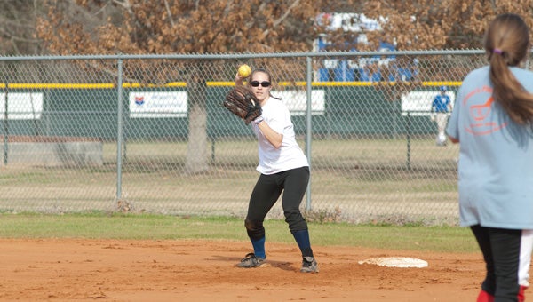 Riley King throws the ball back to the pitcher during practice.
