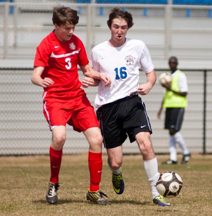 Austin Brooks fights for the ball against a Hillcrest defender. Brooks had three goals and an assist in the game for Demopolis.
