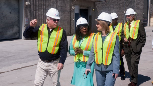 CEMEX Demopolis Plant Manager Gary Pinault (left) guides Rep. Terri Sewell (center) and MCEDA Director Brenda Tuck on a tour of the CEMEX Demopolis plant.