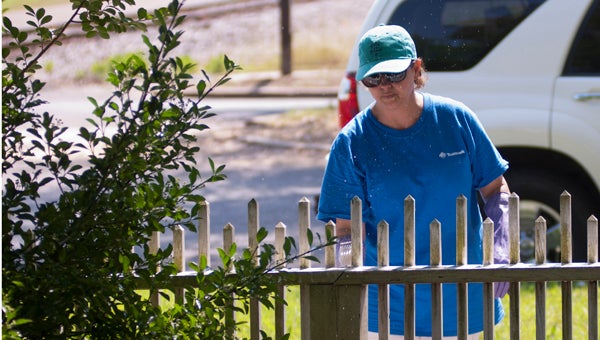 Audrey Yeager works on a fence at Lyon Hall.
