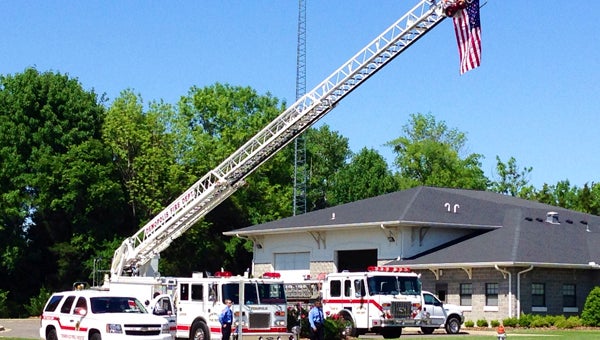 Demopolis firefighters prepare to salute Aubrey Randall's funeral procession Thursday afternoon.