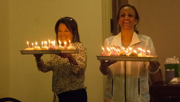Cindy Reeves and Aliquippa Allen bring out birthday cupcakes for the cancer survivors at the Survivor’s Banquet. The American Cancer Society, which puts on Relay For Life events across the country, is “The Official Sponsor of Birthdays.”