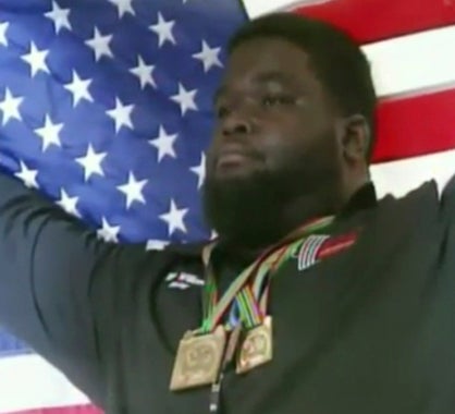 Demopolis native Ray Williams holds up an American flag after winning the International Powerlifting Federation World Championship.