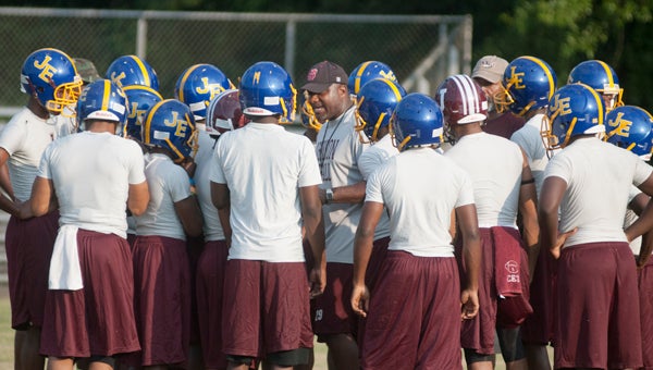A.L. Johnson head coach Johnny Ford motivates his team before the 7-on-7 against Greensboro on Monday.