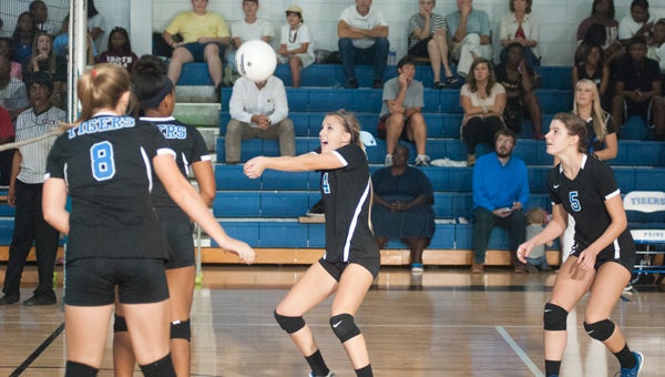 Demopolis junior Katie Marques returns a serve from Wilcox Central as her teammates look on.