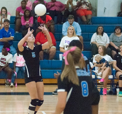 Jade Montgomery sets a teammate up for a spike.