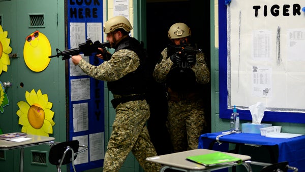 Officers enter a classroom at Demopolis Middle School during active shooter training Wednesday night.