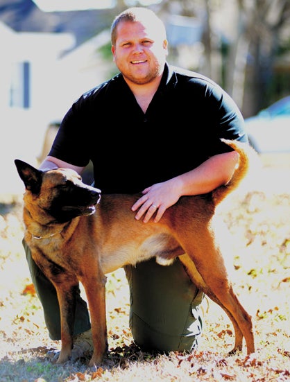 Task Force Commander Clint Sumlin is shown with his new dog, Taz.