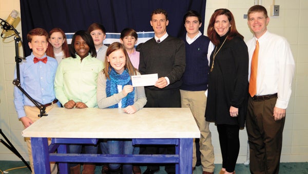 Robertson Banking Company donated $1,000 to the Demopolis Middle School Tiger TV broadcast Tuesday. Shown are Abby Hulsey, Kylah Wheeler, Grant Patterson, Joseph Barnes, Larson Jackson, Trey Malone, Robertson Banking Company Executive Vice President Pete Reynolds, Russell Dial, teacher Meggin Mayben and principal Blaine Hathcock.