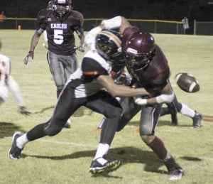 Marengo’s Deangelo Crispin knocks the ball away from A.L. Johnson ballcarrier Desmond Mair in an in-county rivalry game Friday night in Thomaston.