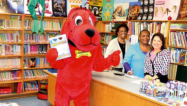 Pictured above is Clifford with three of the volunteers helping with the book fair, from left, Dot Russell, Erma Banks, and Cindy Reeves.