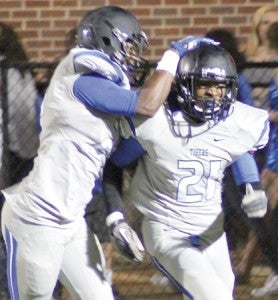 Demopolis celebrates an interception returned for a touchdown by A.J. Collier (26). He had two pick-sixes in the game.
