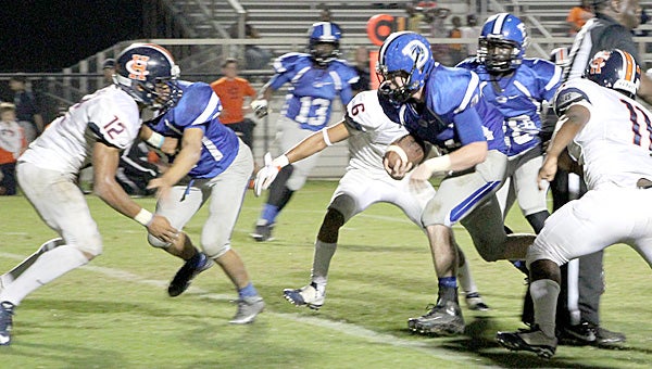 Drew Jones picks up big yardage for the Tigers during Thursday night's first-round playoff game against Charles Henderson High School.