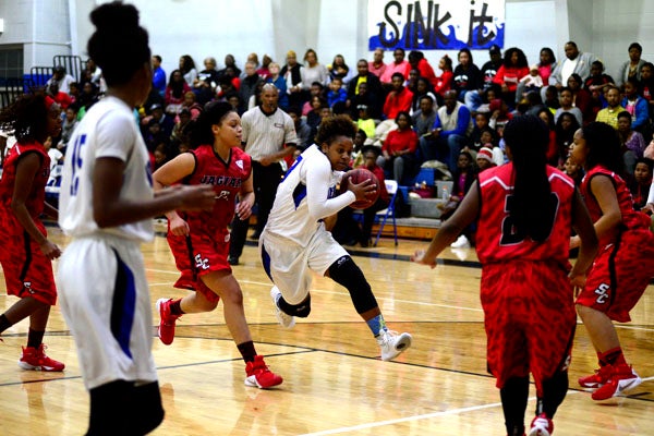Sha'Deitra White tries to find room through the Sumter Central defense on the way to the hoop. 