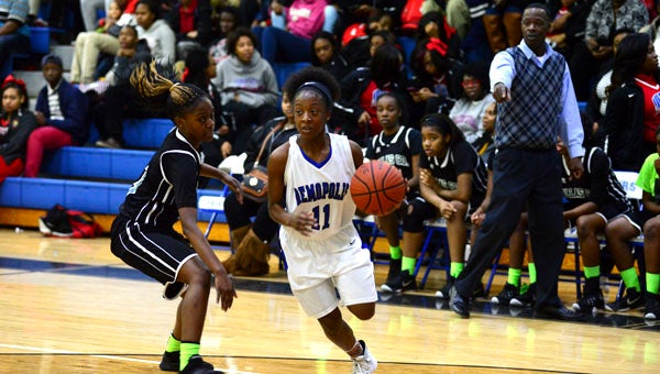 Erica Bennett drives to the hoop against a Dallas County defender. 