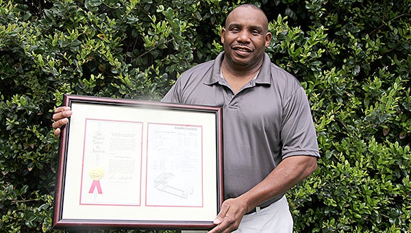 Demopolis native Henry Shepherd holds the U.S. Patent on his “Shepherd Safe Station,” a device that securely and safely keeps irons on an ironing board.