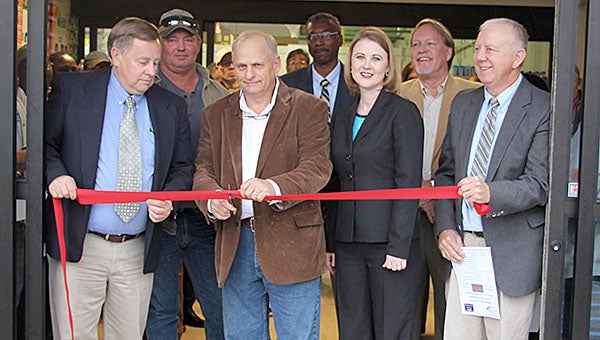 Helping cut the ribbon to Dave’s Market in Thomaston are, from left, (front) Mayor Jeff Laduron; David Oliver, owner; MCEDA Executive Director Brenda Tuck, County Commission Chairman Dan England; (back) Jerry Atchison, project manager; USDA Rural Development Area Director Nivory Gordon, and Alabama Tombigbee Regional Commission Frank Dobson.