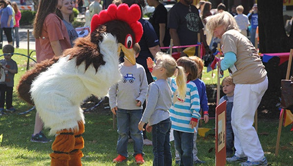 Children getting to know Brewster the Rooster during Rooster Day held in downtown Demopolis April 9.