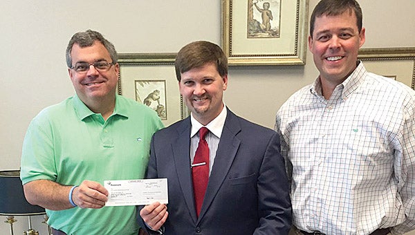 Trustmark National Bank made a $500 donation to the Demopolis City School system for Autism Awareness Month. Pictured above are, Valley Harrison, left, and Charles Singleton, right, of Trustmark Bank with Demopolis City Schools Superintendent Kyle Kallhoff. 