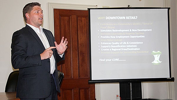 Scott Emison, director of retail strategy with The Retail Coach, speaks to a group gathered at Rooster Hall Thursday evening about attracting new retail businesses to downtown Demopolis.