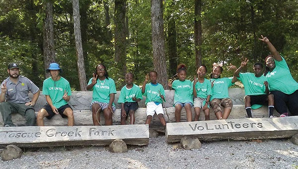 Volunteers, including youths from the Theo Ratliff Center, spent Saturday helping with clean-up efforts at Foscue Park.