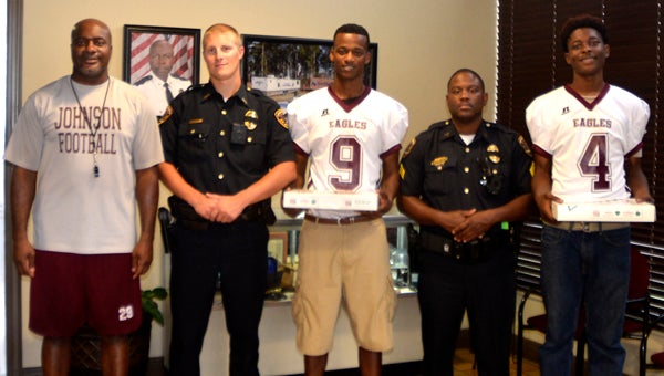 The A.L. Johnson Eagles visited every police department in Marengo Academy to deliver some fresh Krispy Kreme doughnuts in honor of their service to the community. Picture here are Eagles Head Coach Johnney Ford, Demopolis Police Department Officer Scott Cannon, Leo Baker, DPD Officer Don Johnson and Deaundra Bridges. 
