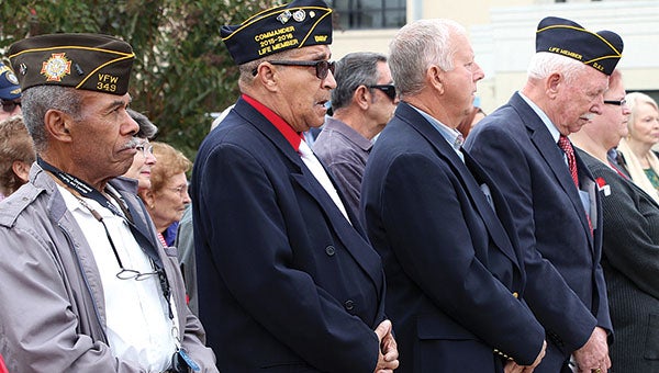 Veterans stand together Friday at a Veterans Day program held at Bryan W. Whitfield Memorial Hospital.